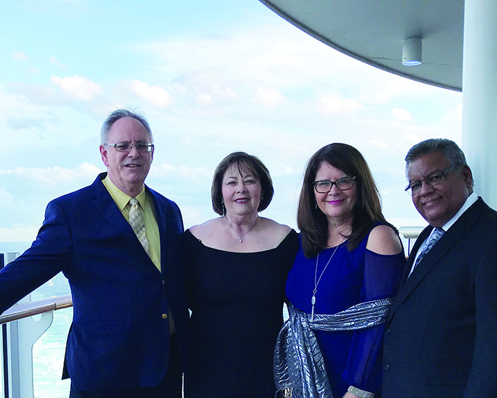 Ray and Marie Tregre are joined by Elena and Junior Pagán before attending the Captain's Dinner on the cruise 